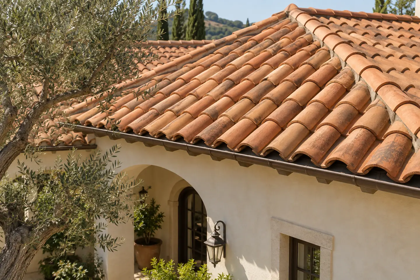 Curved terracotta clay tiles on a stucco home