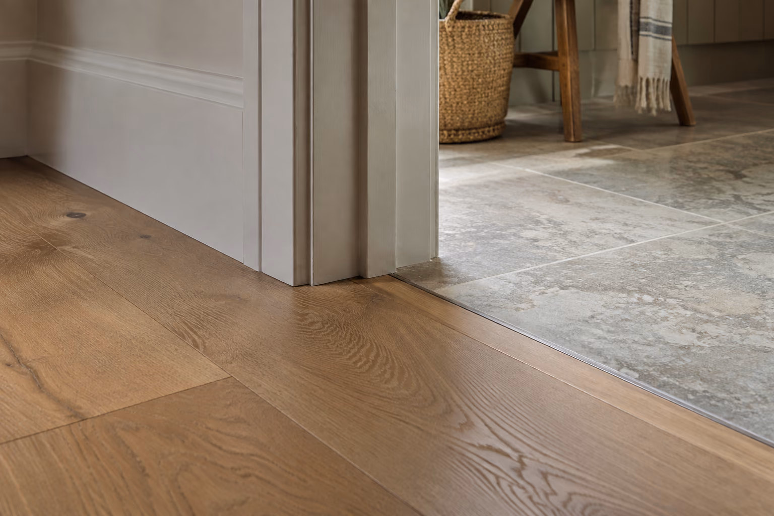 A neat transition between oak flooring and an adjoining tiled room.