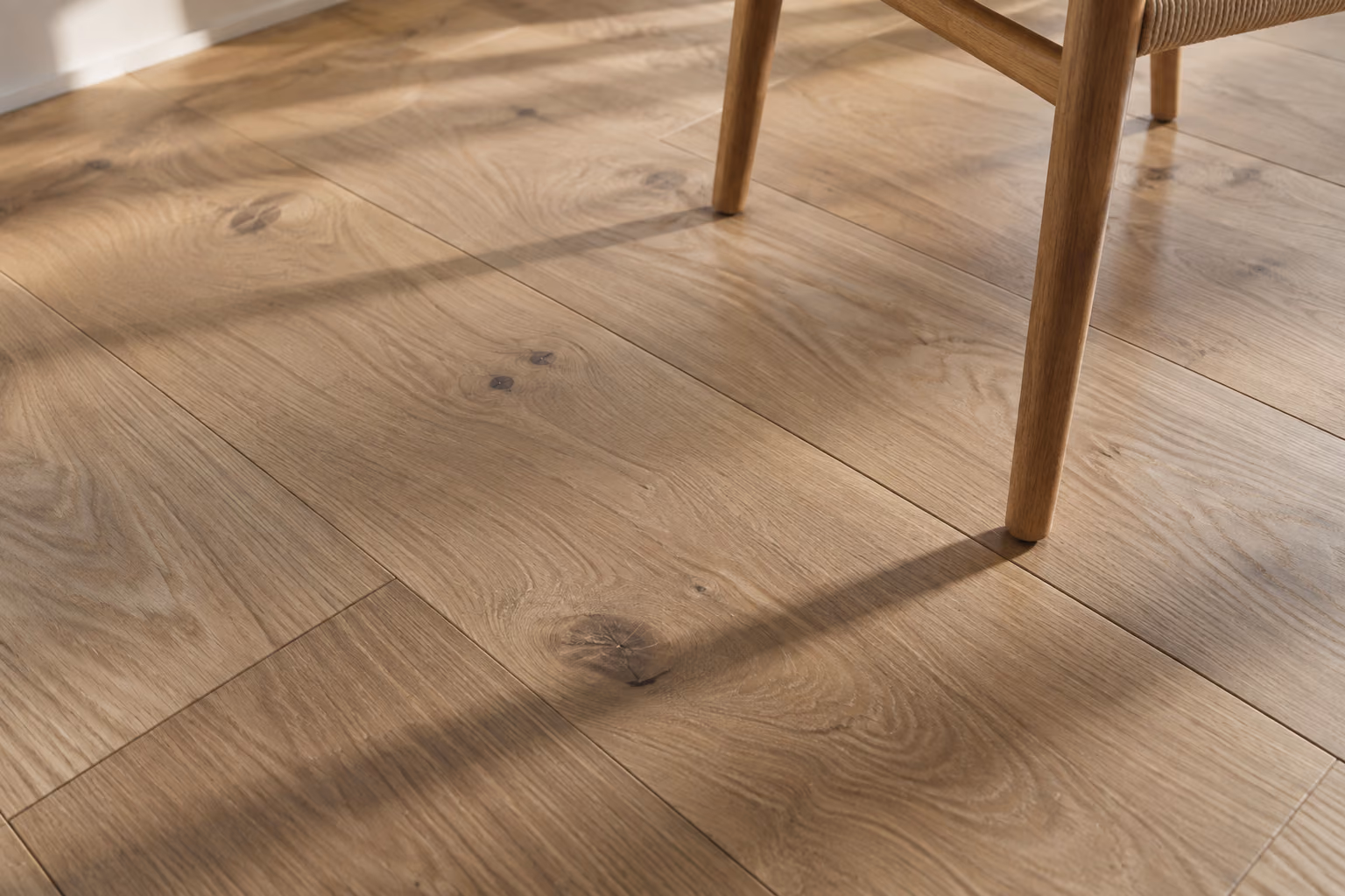 Natural grain and subtle knots in solid oak flooring.